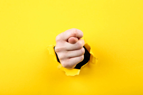 Hand from yellow torn paper - Фото, зображення