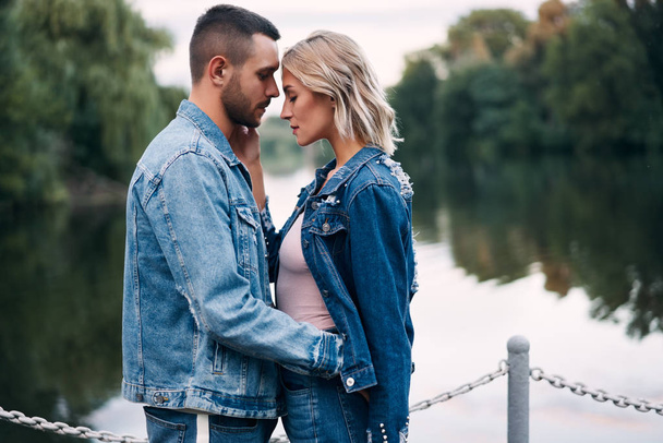 Beautiful fashionable couple posing together outdoors - Foto, afbeelding