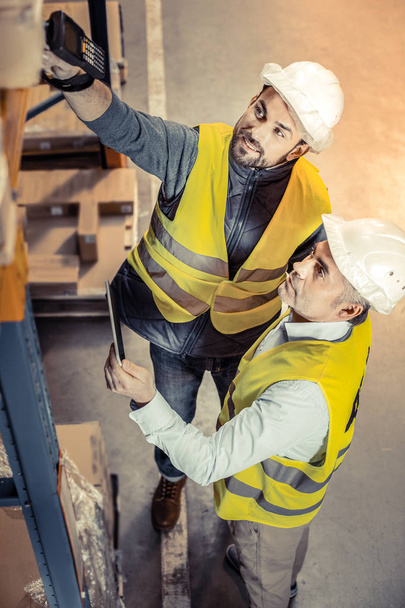 Top view of pleased man that checking warehouse - Photo, Image