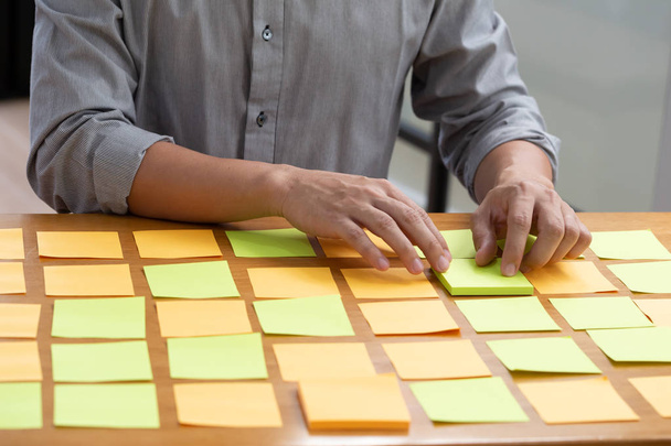 Задача бизнес-планирования работа с липкой запиской на столе в офисе
 - Фото, изображение