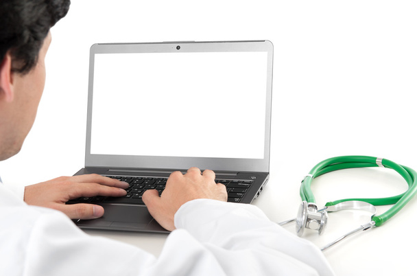 doctor and laptop with blank screen - Foto, afbeelding