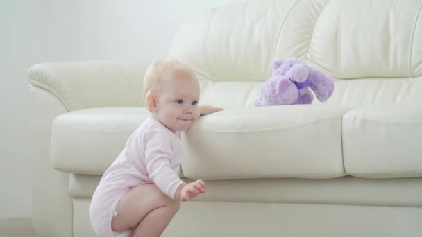 Children, infant and childhood concept - beautiful smiling baby is playing - Záběry, video