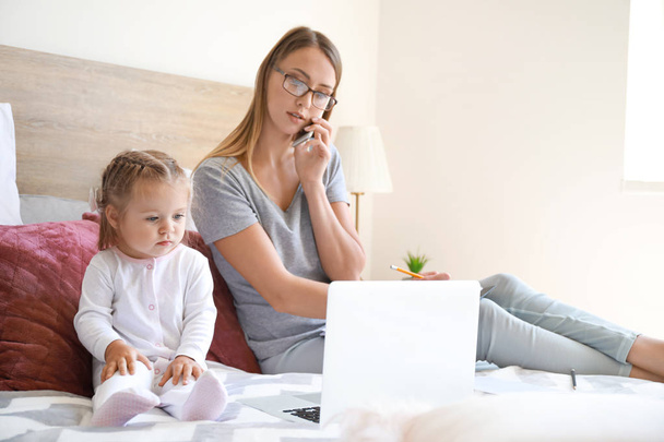 Working mother with her daughter  in bedroom at home - Photo, Image
