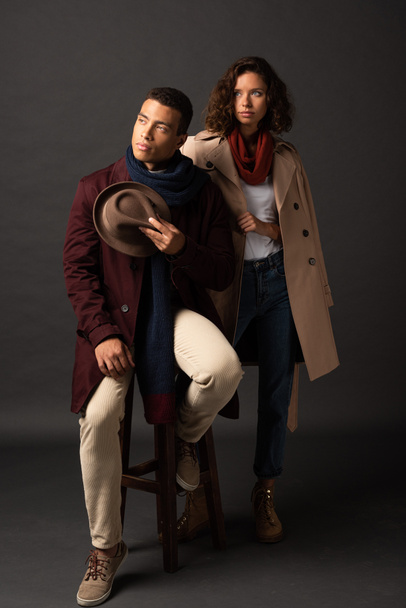 elegant interracial couple in autumn outfit looking away - Photo, Image