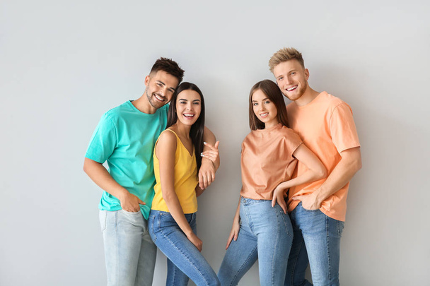 Group of young people in stylish casual clothes on light background - Foto, afbeelding