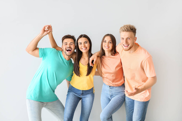 Group of young people in stylish casual clothes on light background - Photo, Image