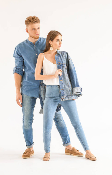 Fashionable young couple in stylish casual clothes on white background - Photo, Image