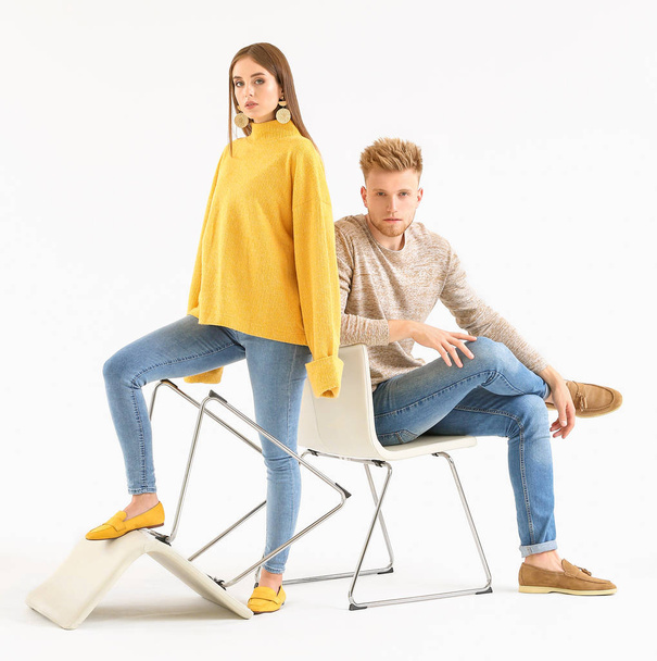 Fashionable young couple in stylish casual clothes on white background - Photo, Image