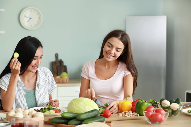 Beautiful women cooking together in kitchen - Foto, Imagem