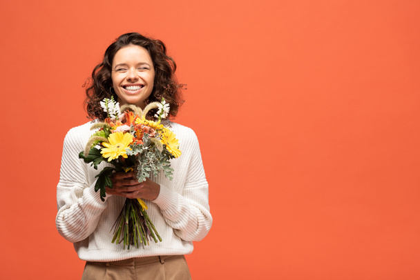 Szczęśliwa Kobieta w jesienny strój gospodarstwa bukiet kwiatów na pomarańczowo - Zdjęcie, obraz
