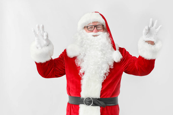 Happy Santa Claus showing OK gesture on white background - Fotó, kép