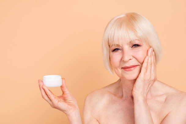 Close up photo beautiful amazing mature she her aged model lady touch smooth face recommend new procedure hold arm hand cream aesthetic ideal appearance nude isolated pastel beige background - Fotó, kép