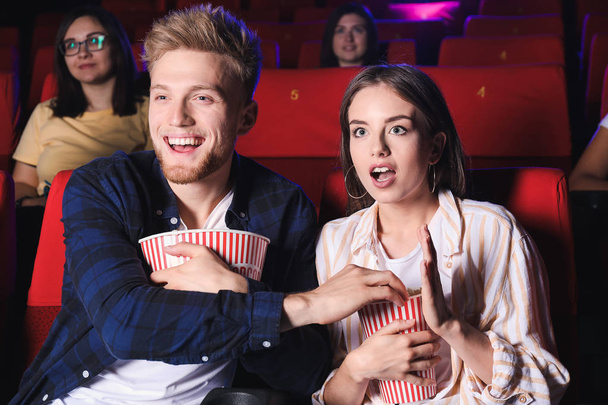 Koppel met popcorn kijken film in de bioscoop - Foto, afbeelding