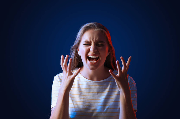 Portrait of angry woman on dark background - Photo, Image