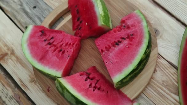 Fresh sliced watermelon wooden background in the garden - Footage, Video