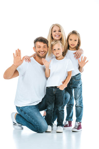 happy parents and kids waving hands and looking at camera on white - Foto, imagen