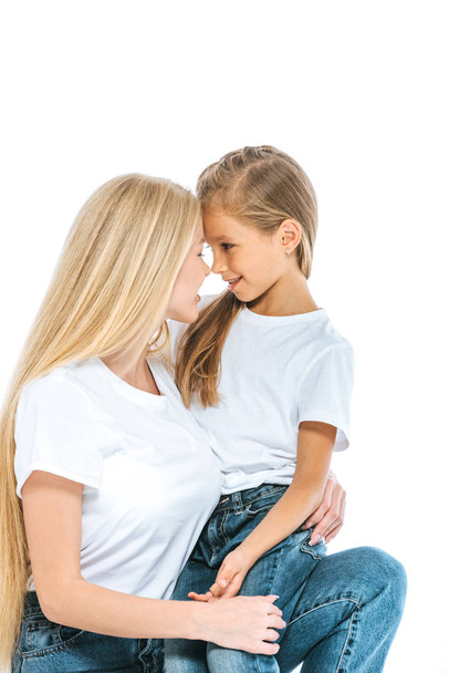 happy mother and preteen daughter looking at each other isolated on white - Foto, Imagem