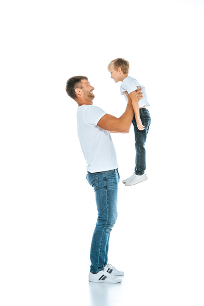 happy dad holding in arms cute son on white - Foto, imagen