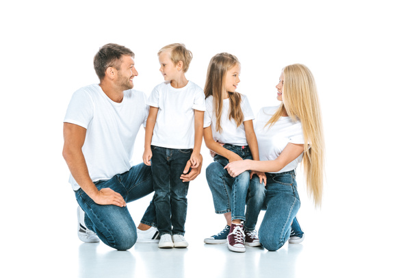 happy man looking at son near wife and daughter on white  - Photo, Image