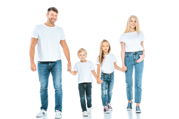 smiling parents holding hands with cheerful kids on white  - Фото, зображення