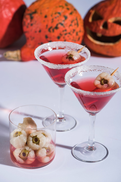 red Halloween cocktails with decoration in glasses on white surface - Zdjęcie, obraz