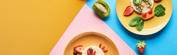 Nejlepší pohled na talíře s fantastými zvířaty z potravin pro děti na modrém, žlutém a růžovém pozadí - Fotografie, Obrázek