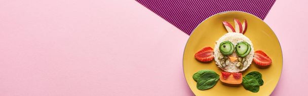 top view of plate with fancy cow made of food on pink and purple background - Photo, Image