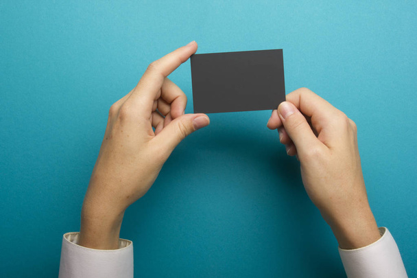 Hand holding business card blank on abstract background - 写真・画像