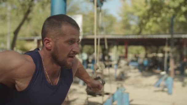 Portrait of fit man exercising on cable crossover - Felvétel, videó