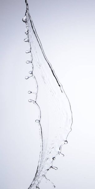 Moving water on white background, jets and drops - Zdjęcie, obraz