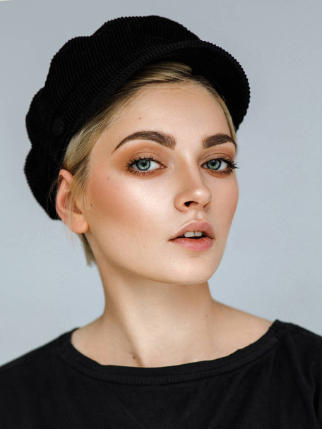 Beauty portrait of fashion young model with short hair and black cap - Fotó, kép