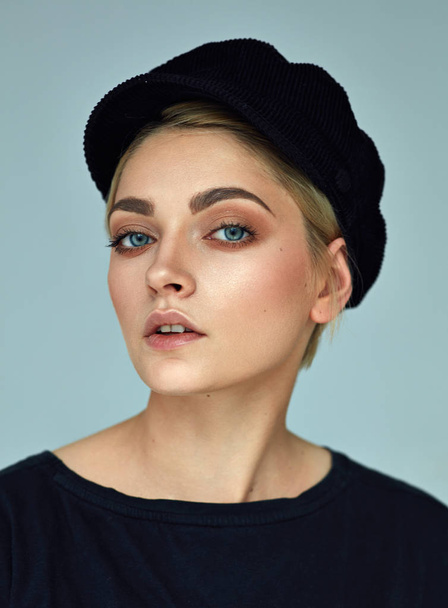 Beauty portrait of fashion young model with short hair and black cap - Foto, imagen