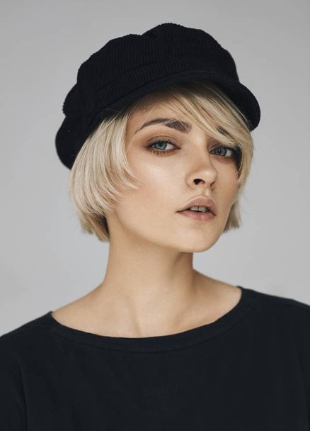 Beauty portrait of fashion young model with short hair and black cap - Fotó, kép
