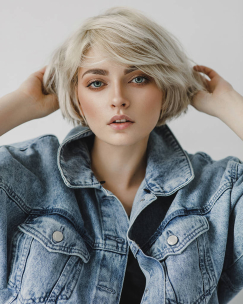 Portrait of fashion blonde woman with short hair wearing denim jacket  - Fotografie, Obrázek