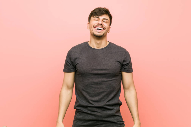 Young hispanic casual man relaxed and happy laughing, neck stretched showing teeth. - Foto, Imagem