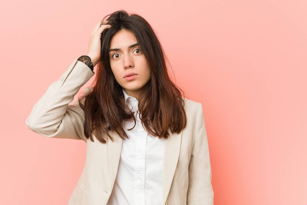 Young brunette business woman against a pink background tired and very sleepy keeping hand on head. - Foto, imagen