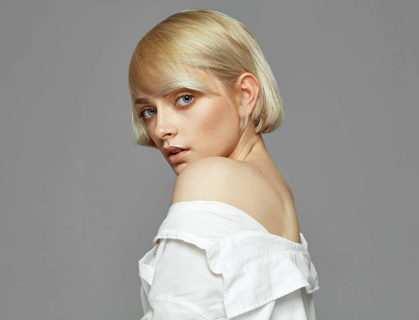 Portrait of blonde woman with short hair wearing white shirt - Fotoğraf, Görsel