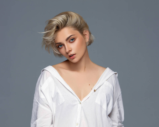 Portrait of blonde woman with short hair wearing white shirt - Photo, Image
