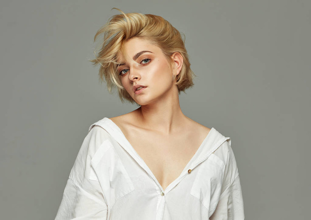 Portrait of blonde woman with short hair wearing white shirt - Photo, image