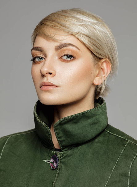 Portrait of blonde woman in green retro style jacket - Photo, Image