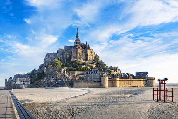 Dawn in Mont Saint Michel and its abbey with the sea at low tide - Photo, Image
