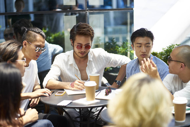 азіатські студенти коледжу зустрічаються на відкритому повітрі
 - Фото, зображення