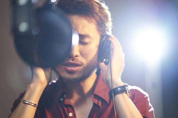 young asian musician recording songs in studio - Photo, Image