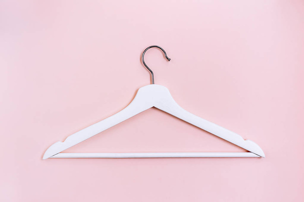 White wooden hanger on pink background - Foto, Imagen