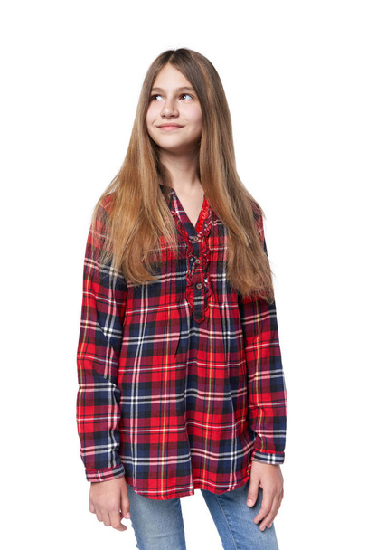Teen girl in checkered shirt standing casually - Фото, изображение