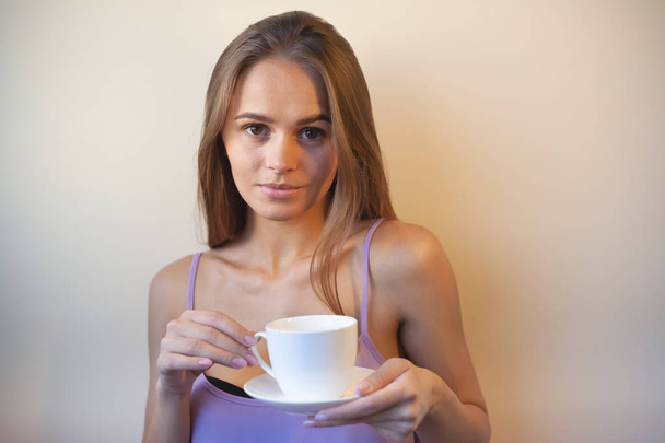 Young woman enjoying a cup of coffee. Portrait of female with morning tea. Copy space - Photo, image