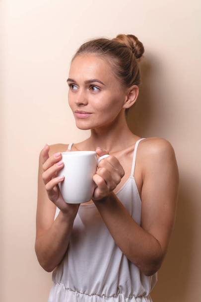 Young woman enjoying a cup of coffee. Portrait of female with morning tea. Copy space - Fotó, kép