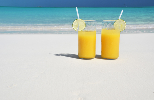 Orange juice on the beach. - Valokuva, kuva