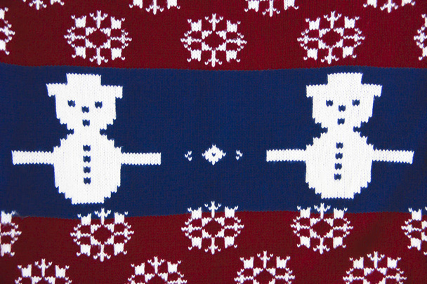 texture of knitted fabric red blue with white pattern a snowman - Photo, Image