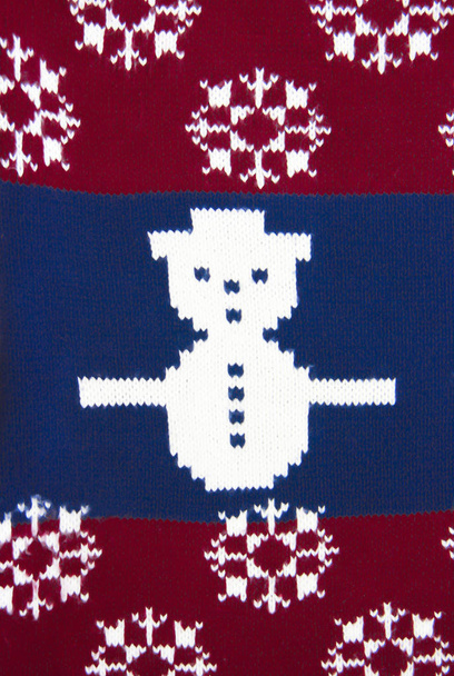 texture of knitted fabric red blue with white pattern a snowman - Photo, Image